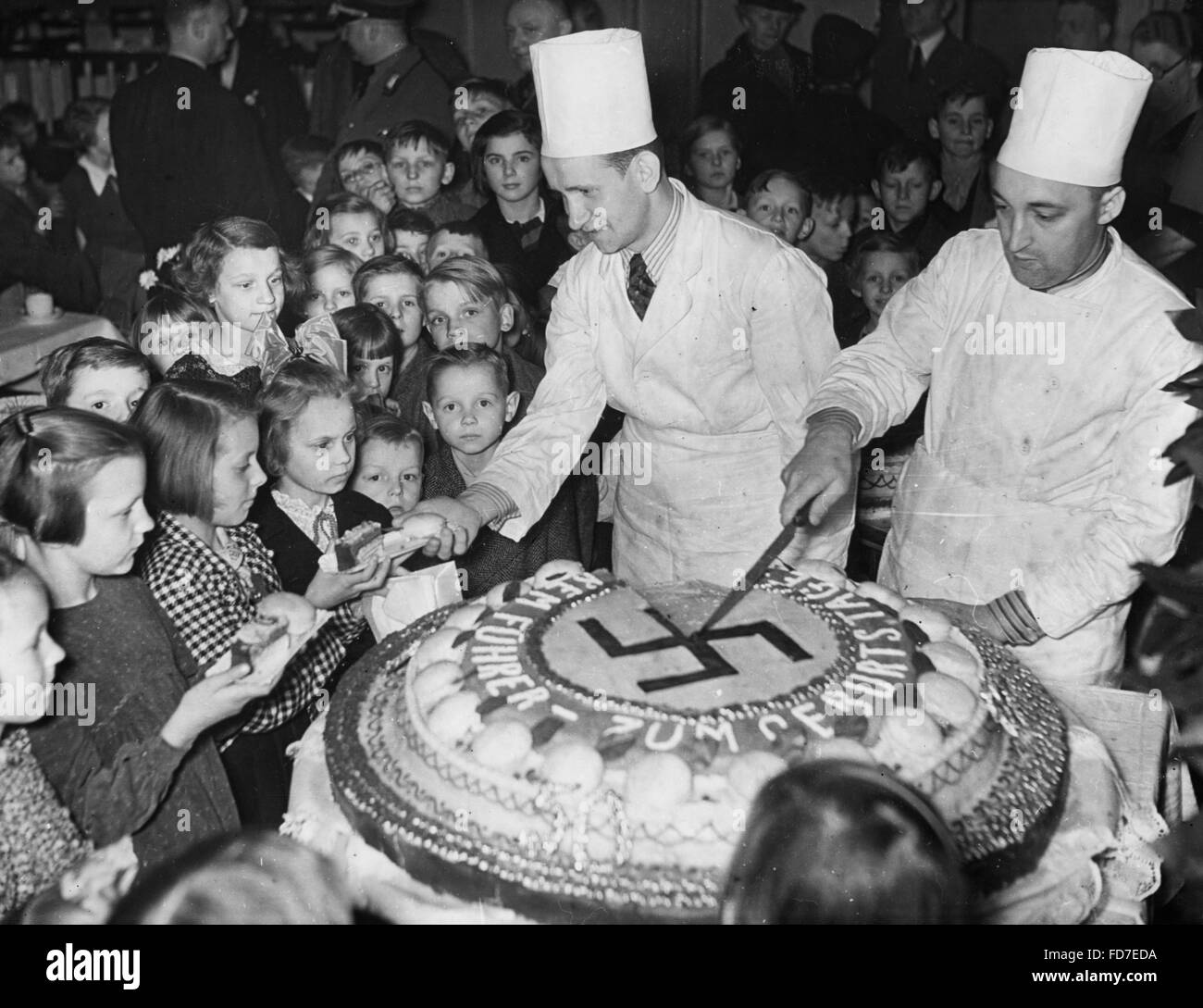 the-birthday-cake-of-adolf-hitler-is-shared-with-children1939-FD7EDA.jpg